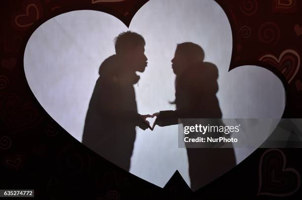 Hinese couple embrace at kiss box in Harbin city of China on 14 February 2017.Many Chinese couples choose Valentine's Day to celebrate love as the...