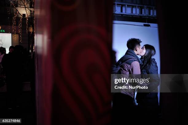 Hinese couple embrace at kiss box in Harbin city of China on 14 February 2017.Many Chinese couples choose Valentine's Day to celebrate love as the...