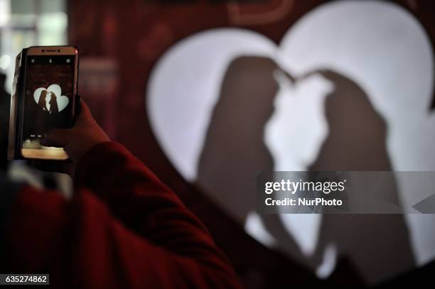 Chinese couple embrace at kiss box in Harbin city of China on 14 February 2017.Many Chinese couples choose Valentine's Day to celebrate love as the...