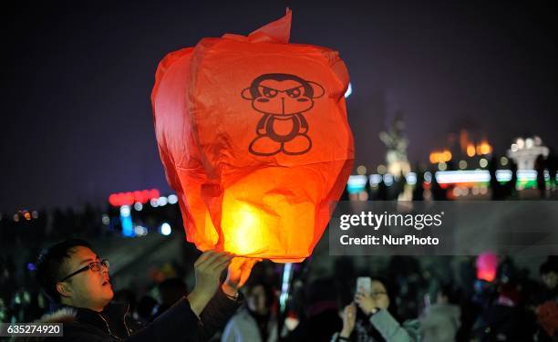 Couple is flying Kongming lantern to mark Valentine's Day at Songhuajiang River in Harbin city of China on 14 February 2017.Many Chinese couples...