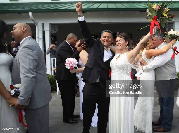 Richard Agudelo and Monica Guzman react after being wed during a group Valentine's day wedding at the National Croquet Center on February 14, 2017 in...