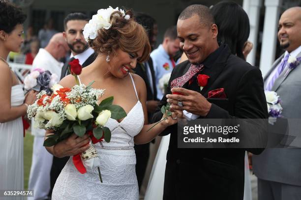 Wendy Ramirez and Anthony Moore prepare to exchange rings during a group Valentine's day wedding at the National Croquet Center on February 14, 2017...