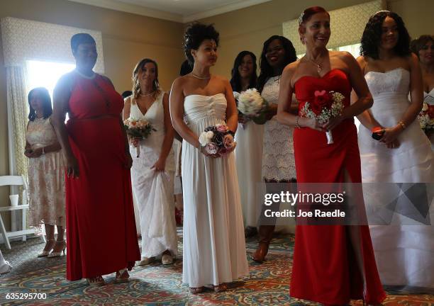 Brides wait to participate in a group Valentine's day wedding ceremony at the National Croquet Center on February 14, 2017 in West Palm Beach,...