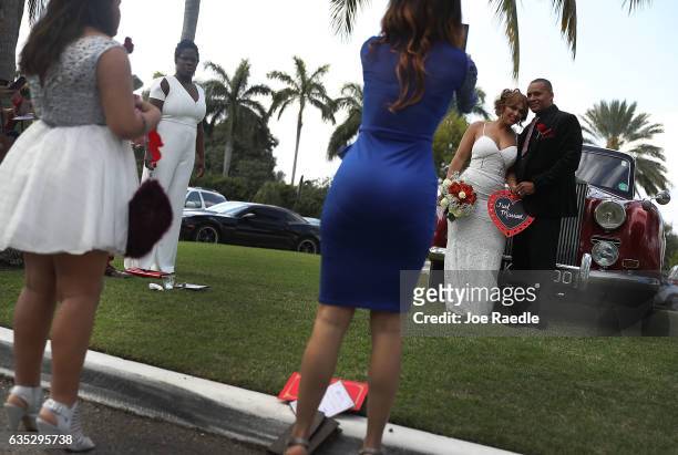 Wendy Ramirez and Anthony Moore pose for pictures after being married during a Valentine's day wedding ceremony at the National Croquet Center on...