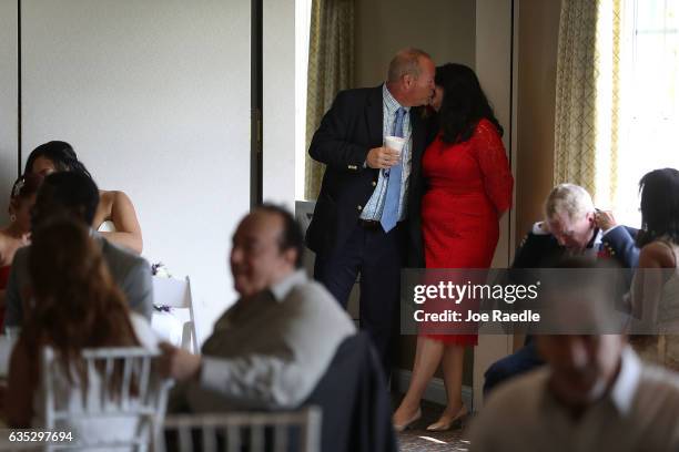 Sean Logsdon and Tina Logsdon kiss as they prepare to be married in a group Valentine's day wedding ceremony at the National Croquet Center on...