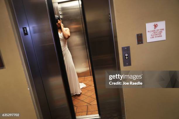 Tiffany Hinds arrives in an elevator for the group Valentine's day wedding ceremony at the National Croquet Center on February 14, 2017 in West Palm...