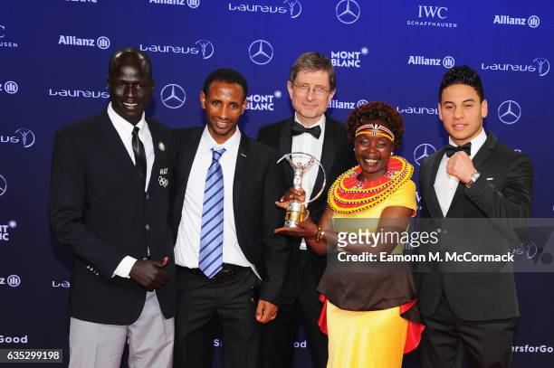 The Winners of the Laureus Sport for Good the Olympic Refugee team pose with their trophy and Laureus Academy Member Tegla Loroupe at the Winners...