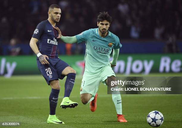 Paris Saint-Germain's French defender Layvin Kurzawa vies with Barcelona's Portuguese midfielder Andre Gomes during the UEFA Champions League round...