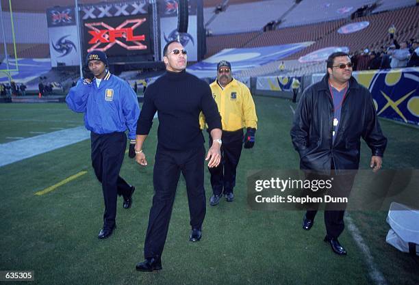 S "The Rock" walks out to greet the fans before the game between the Los Angeles Xtreme and the Chicago Enforcers at the L.A. Coliseum in Los...