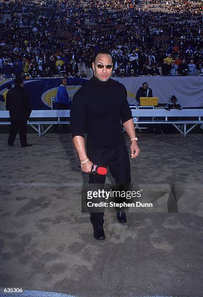 S "The Rock" stands ready to talk to the fans before the game between the Los Angeles Xtreme and the Chicago Enforcers at the L.A. Coliseum in Los...