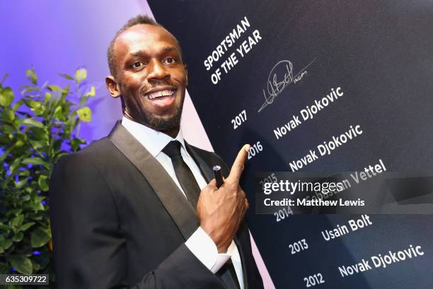 Winner of the Laureus World Sportsman of the Year Award Athlete Usain Bolt of Jamaica writes his name on a winners board after the Laureus World...