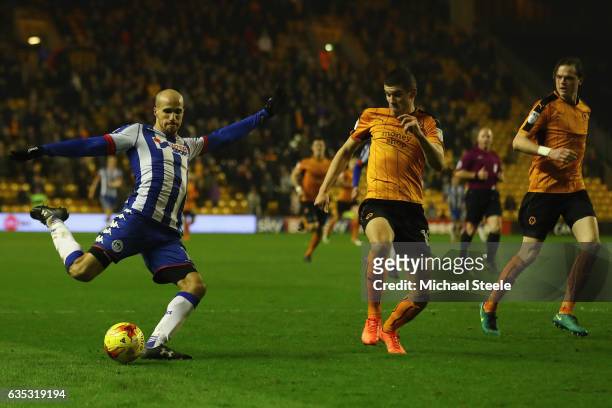 Gabriel Obertan of Wigan shoots as Conor Coady of Wolverhampton closes in during the Sky Bet Championship match between Wolverhampton Wanderers and...