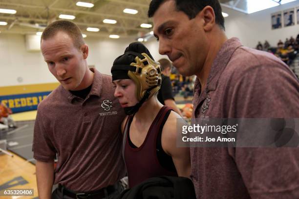 Silver Creek High School's Olivia Ioppolo, at 106 pounds walks from the mat with her head coach John Finkbiner and her father assistant coach Albert...