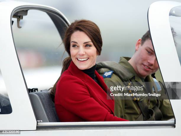 Catherine, Duchess of Cambridge sits in the cockpit of a Grob 115E 'Tutor' aeroplane during a visit to RAF Wittering to meet air cadets taking part...