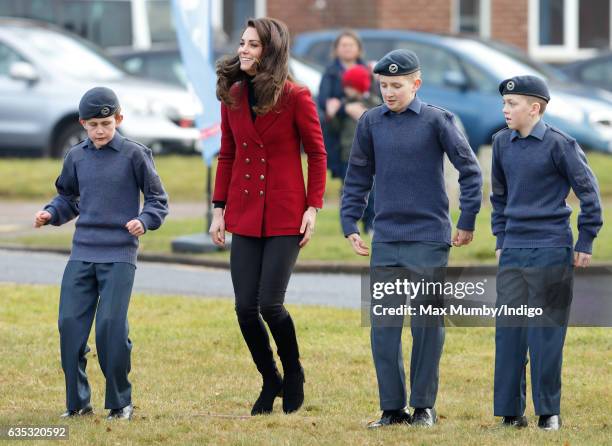 Catherine, Duchess of Cambridge joins in with a team building exercise during a visit to RAF Wittering to meet air cadets taking part in a half-term...