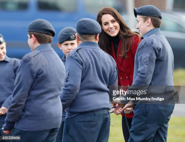 Catherine, Duchess of Cambridge joins in with a team building exercise during a visit to RAF Wittering to meet air cadets taking part in a half-term...