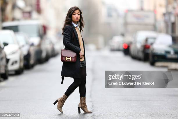 May Berthelot, Head of Legal at Videdression.com and fashion blogger, wears Zara camel suede boots, a The Kooples black leather short, a Topshop...