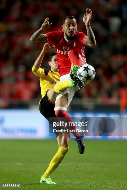 Kostas Mitroglou of Benfica battles for the ball with Marc Bartra of Dortmund during the UEFA Champions League Round of 16 first leg match between SL...