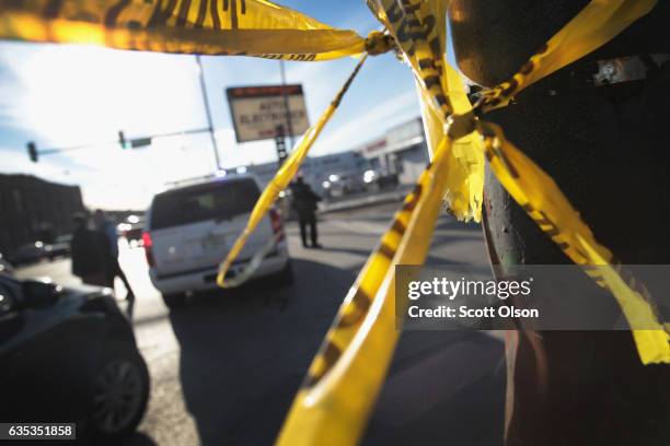 Police investigate the scene of a shooting where a two-year-old child, and a man in his twenties were killed and a pregnant woman was wounded in the...