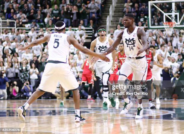 Cassius Winston, Eron Harris and Kenny Goins of the Michigan State Spartans celebrates a basket during the game against the Ohio State Buckeyes in...