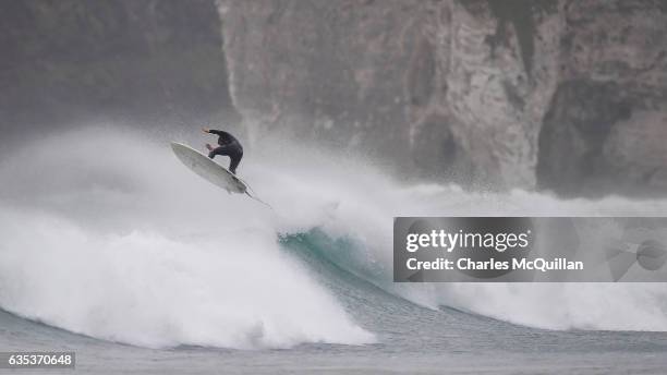 Surfer Al Mennie catching some serious air on a wave beneath Dunluce Castle on October 31, 2016 in Portrush, Northern Ireland.