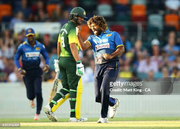 Lasith Malinga of Sri Lanka celebrates taking the wicket of D'Arcy Short of the Australian PMXI during the T20 warm up match between the Australian...