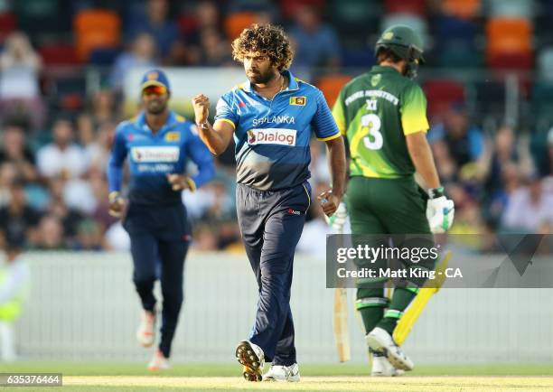 Lasith Malinga of Sri Lanka celebrates taking the wicket of D'Arcy Short of the Australian PMXI during the T20 warm up match between the Australian...