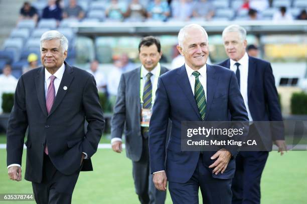 The Prime Minister of Australia Malcolm Turnbull and Sri Lankan Prime Minister Ranil Wickremesinghe walk out to take part in the coin toss during the...