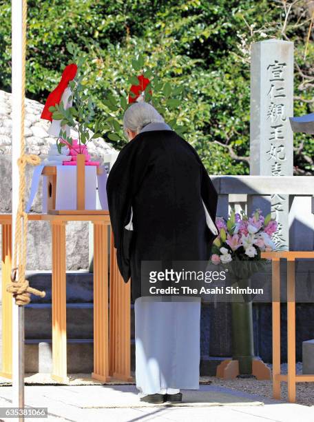 Empress Michiko bows at an altar during a memorial ceremony at the grave of late Prince Takamatsu, Emperor Akihito's uncle, marking the 30th...