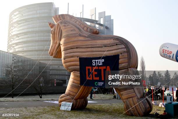 Protestors stand in front of a Trojan Horse balloon with a banner reading 'Stop Ceta' as they demonstrate against the Transatlantic Trade and...