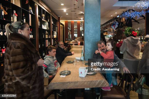 Child sits with her parents for lunch at a table in the Antonio Ferrari restaurant on February 15, 2017 in Padova, Italy. The restaurant offers a 5%...