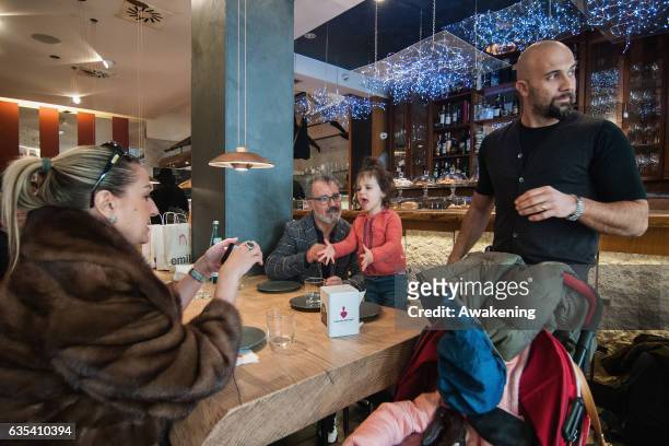 Child sits with her parents for lunch at a table in the Antonio Ferrari restaurant on February 15, 2017 in Padova, Italy. The restaurant offers a 5%...