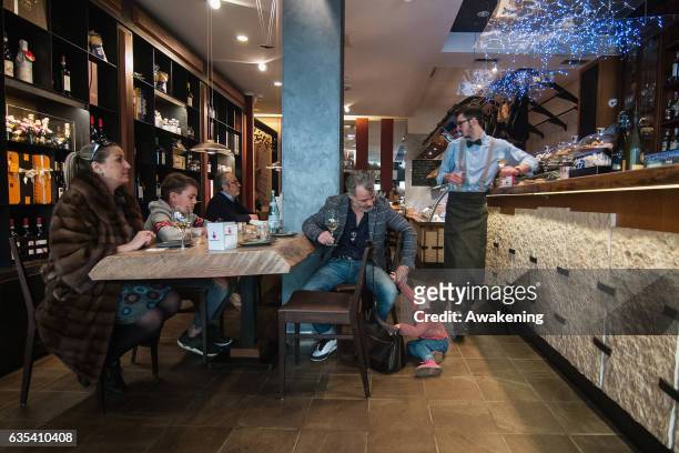 Children sit with their parents for lunch at a table in the Antonio Ferrari restaurant on February 15, 2017 in Padova, Italy. The restaurant offers a...