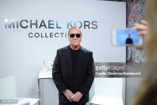 Designer Michael Kors poses backstage before the Michael Kors Collection Fall 2017 runway show at Spring Studios on February 15, 2017 in New York...