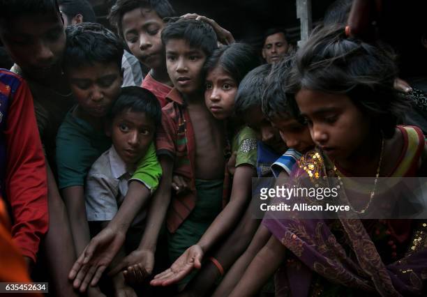 Rohingya refugees gather, hoping to get relief supplies donated by the crew of the Nautical Aliya in the Leda Rohingya refugee camp on February 15,...