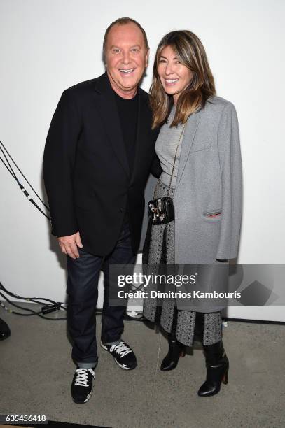 Designer Michael Kors and Nina Garcia pose backstage at the Michael Kors Collection Fall 2017 runway show at Spring Studios on February 15, 2017 in...