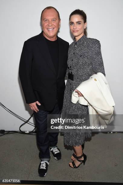 Designer Michael Kors and actress Amanda Pee pose backstage before the Michael Kors Collection Fall 2017 runway show at Spring Studios on February...