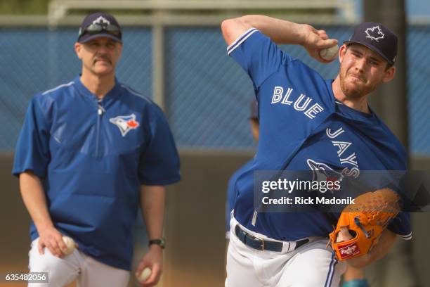 Pitcher Joe Biagini throws under the watchful eye of pitching coach Pete Walker. Toronto Blue Jays first day of formal workouts at Bobby Mattick...