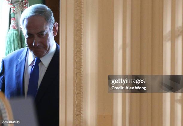 Israel Prime Minister Benjamin Netanyahu enters the East Room of the White House to participate in a joint news conference with U.S. President Donald...