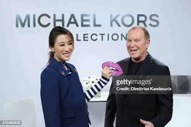 Jennifer Tse and Michael Kors speak at the Michael Kors Collection Fall 2017 runway show at Spring Studios on February 15, 2017 in New York City.