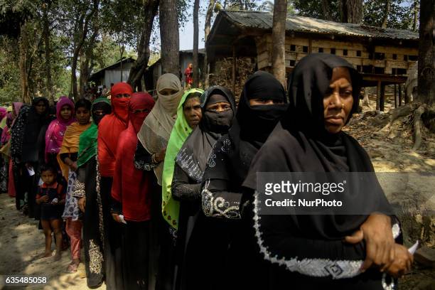Ethnic minority Rohingya waits their turn to collect the distributions humanitarian aid at the Balu Khali Rohingya refugee camp on February 15, 2017....