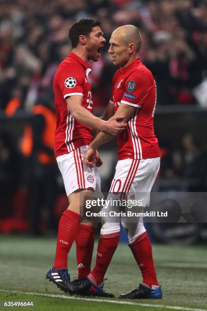 Arjen Robben of Bayern Munich celebrates with his team-mate Xabi Alonso after scoring the first goal during the UEFA Champions League Round of 16...