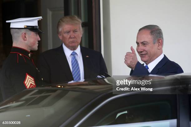 President Donald Trump escorts Israel Prime Minister Benjamin Netanyahu to his waiting vehicle following meetings at the White House February 15,...