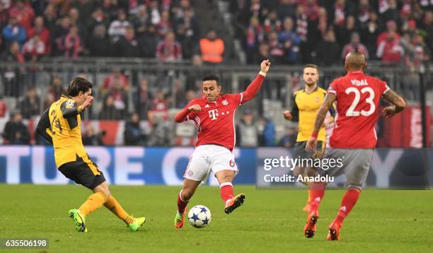 Thiago of FC Bayern Munich in action against Hector Bellerin of Arsenal during the UEFA Champions League round of 16 soccer match between FC Bayern...