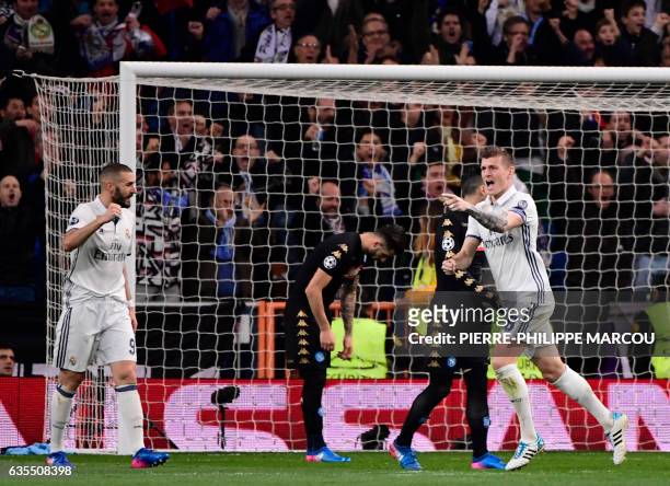 Real Madrid's German midfielder Toni Kroos celebrates a goal with teammate Real Madrid's French forward Karim Benzema during the UEFA Champions...