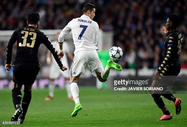 Real Madrid's Portuguese forward Cristiano Ronaldo controls the ball during the UEFA Champions League round of 16 first leg football match Real...