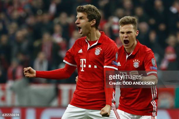 Bayern Munich's forward Thomas Mueller celebrate scoring the 5-1 goal with Bayern Munich's midfielder Joshua Kimmich during the UEFA Champions League...