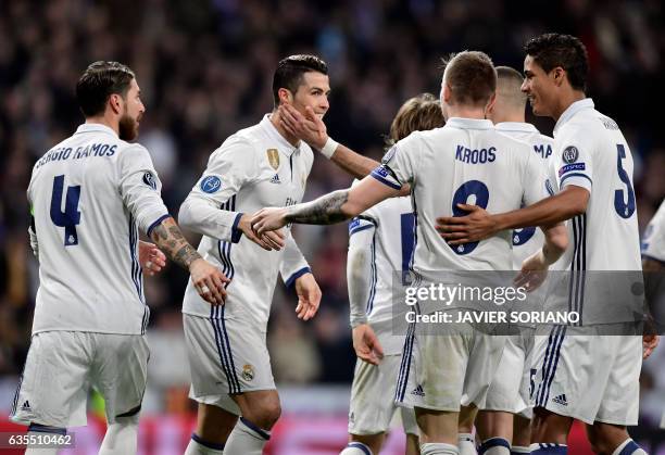 Real Madrid's Portuguese forward Cristiano Ronaldo and teammates celebrate their third goal during the UEFA Champions League round of 16 first leg...