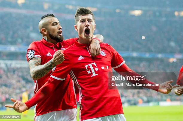 Robert Lewandowski of Bayern Munich celebrates after scoring his team's second goal together with Arturo Vidal during the UEFA Champions League Round...