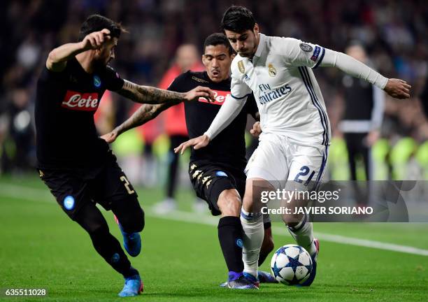 Real Madrid's forward Alvaro Morata vies with Napoli's midfielder from Brazil Allan during the UEFA Champions League round of 16 first leg football...